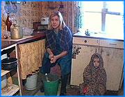 ></p><p class=c_tn>Ветхое жилье как прямая угроза жизни и здоровью. Пятнадцать семей в поселке Озерный Ивановского района  живут в постоянном страхе. Их дом подлежал сносу еще в конце прошлого века, однако до сих пор районные власти не могут предоставить людям новое жилье. Тем временем в нескольких квартирах уже обрушились потолки и жители лишь чудом не пострадали. Дом шесть на Дорожной улице. Его построили в тридцатых. В девяностых вынесли приговор - капремонту не подлежит, сносить. Газ отрубили, тепла нет, но дом все еще стоит, за побуревшими стенами теплится жизнь. </p><p class=c_tn>Дом старел быстрее, чем те, кто отважился в нем жить. Карточный домик - шаткая иллюзия прочности. Спорить с временем и силами разрушения непросто. И, похоже, это испытание выдержали только люди. А то, что было их кровом, превратилось в груду бревен и хрупких перекрытий.</p><p class=c_tn>Виктор Павлович с самого утра терпеливо рубит лед - чтобы вода в трубах не замёрзла. Человек против разрухи, но поединок неравный. Каждой вещи приходит свой срок. В этой комнате рухнула печная труба - теперь жить нельзя ни здесь, ни в квартире наверху.</p><p class=c_tn>«У меня печка рухнула, как раз вот здесь стоял диван, и я спал на нем. Хорошо, что без меня, а то бы покойник, как говорится, был», - говорит Виктор Моренков.</p><p class=c_tn>За столом завтракали дети, когда обрушился кусок потолка. Их семья сумела найти другое жилье, остальные вынуждены мигрировать из одного крыла дома в другой, с этажа на этаж. У Елены Власовой пятеро детей. Четырех мальчиков через соцзащиту пристроили в оздоровительный центр, осталась только маленькая Арина.</p><p class=c_tn>Ольга Тимофеевна ступает по шатким половицам, показывает нам свою квартиру, где больше не живет - боится. Эти стены она когда-то называла домом.  Теперь дома нет.</p><p class=c_tn>«Мне 73 года, и я угла своего не имею. Я скитаюсь по людям. Вот где бы полежать - а мне и полежать негде», - рассказывает Ольга Волкова.</p><p class=c_tn>Прошлым летом людям сказали: ищите квартиры - будем выселять. Обещали каждой семье по восемьдесят тысяч. Цены на жилье в поселке тут же подпрыгнули. И все осталось на своих местах: дом и люди в нём.  </p><p class=c_tn>«Мы обращались к главе администрации товарищу Шилову, он нам ответил, что денег на выселение не было и не будет. Когда мы обратились к заму Тихонова, он нам ответил, что деньги на Ивановский район, на выселение из ветхого фонда, были выделены. Но куда они делись – неизвестно», - говорит Надежда Сенькова.</p><p class=c_tn>Теперь людям предлагают переселиться в здание поселковой администрации. Внешне прочное, внутри - та же разруха. Власти уверяют, что на время - до две тысячи тринадцатого года. А люди понимают, что навсегда. Еще недавно за этими дверьми кипела чиновничья работа. На лестнице - обветшалые символы ушедшей эпохи. Нина Шагурина пришла посмотреть, где ей придется ютиться. Стены в комнатах сломают, но просторнее от этого не станет. На всех переселенцев будет один кран и один унитаз - без вариантов. </p><p class=c_tn>Зимой жизнь в поселке замирает. Вещи съеживаются от холода, люди - от бытовой неустроенности. Чрезвычайная ситуация в отдельно взятом доме никого уже не трогает. Поселок на обочине - значит, в стороне от главной дороги и больших перемен. </p><p class=c_av>Дмитрий Попов</p>
	
		<div class=